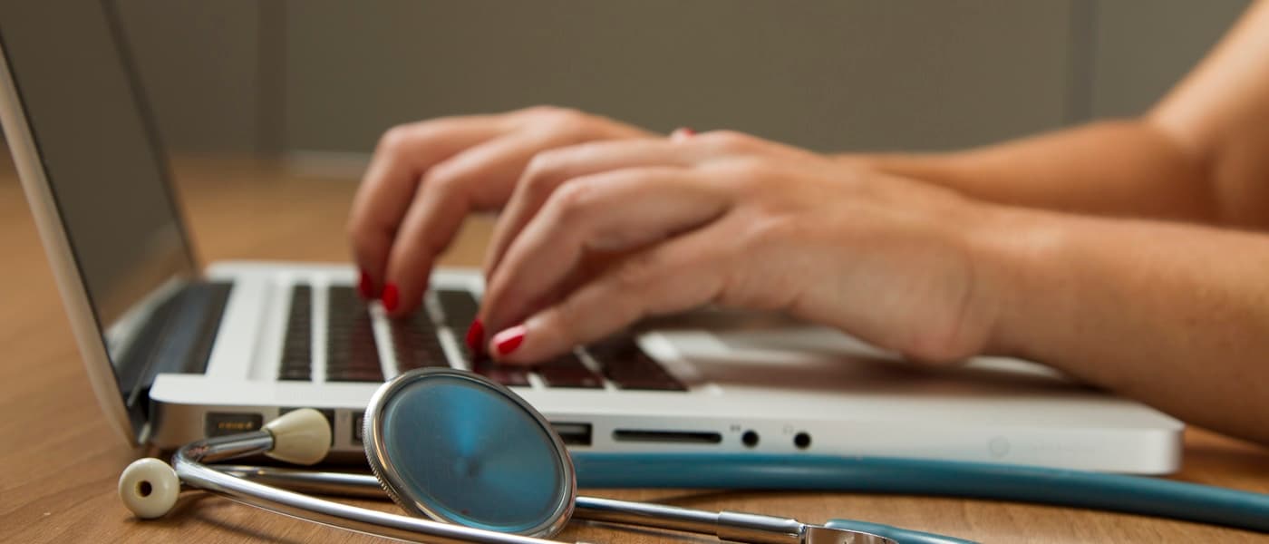 Healthcare provider reviewing notes on a tablet